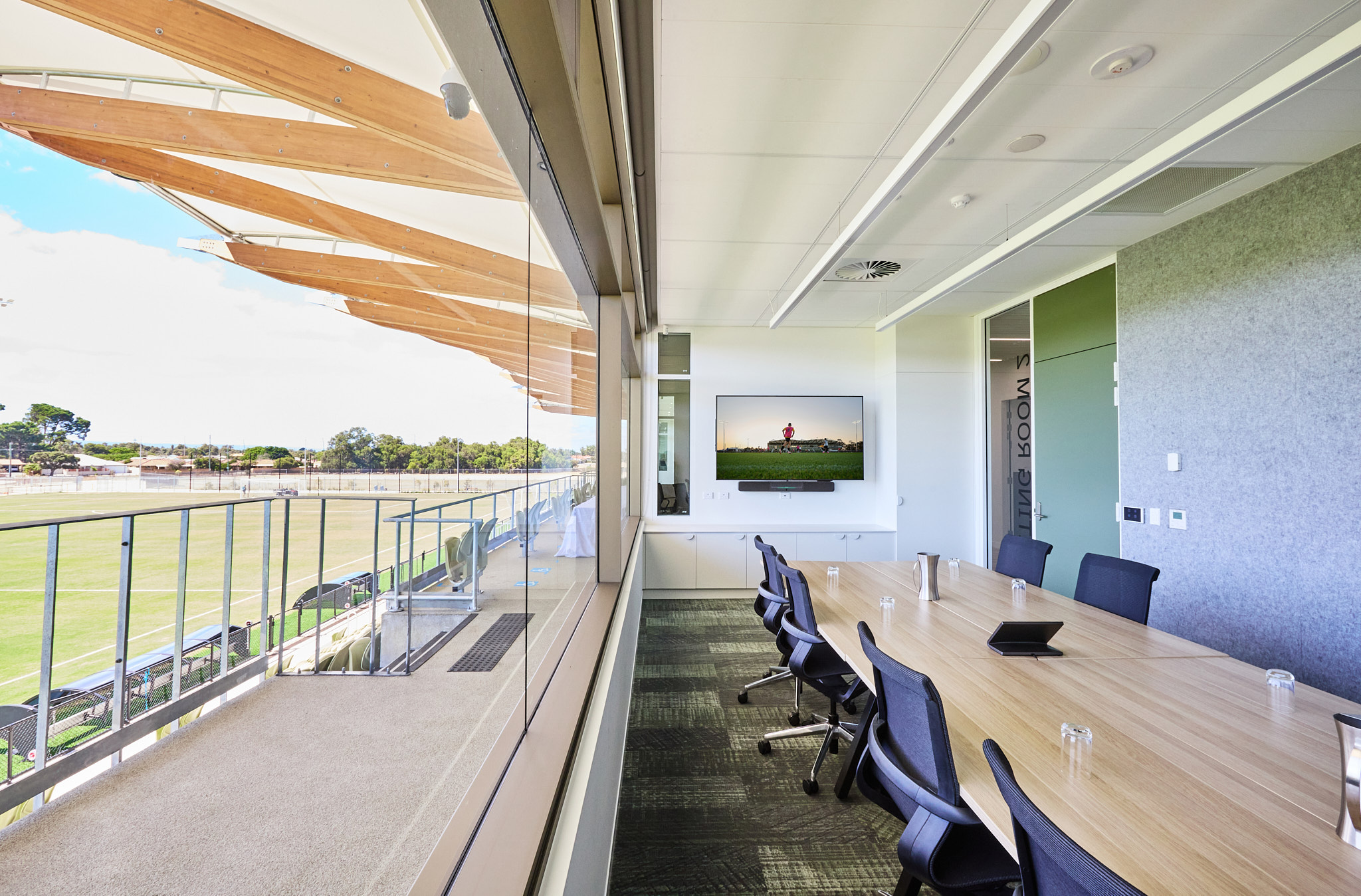 A photo of a boardroom overlooking a football pitch at the Sam Kerr Football Centre in Queens Park, Perth