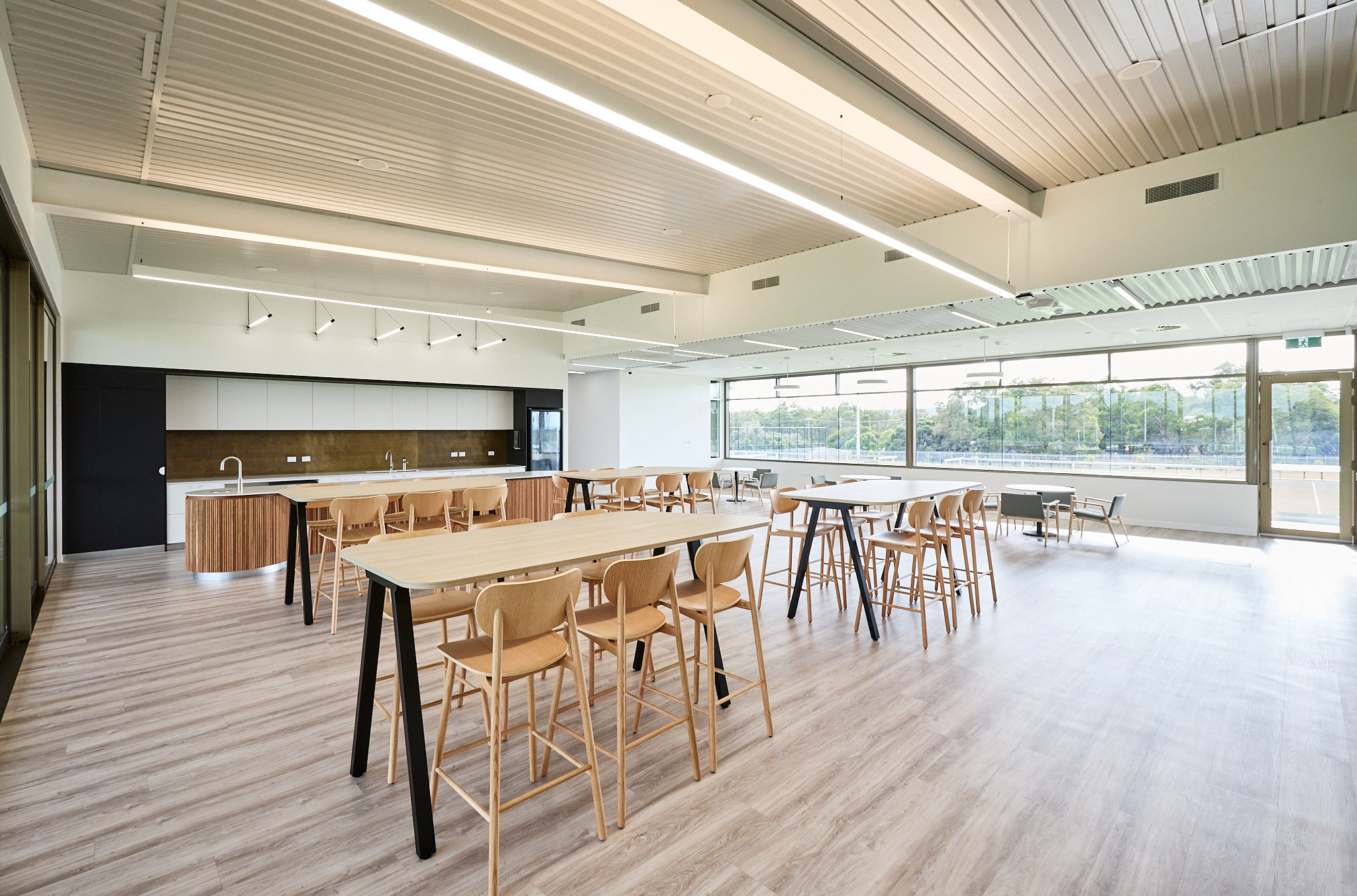 A photo of tables and chairs near a kitchen area at the Sam Kerr Football Centre in Queens Park, Perth