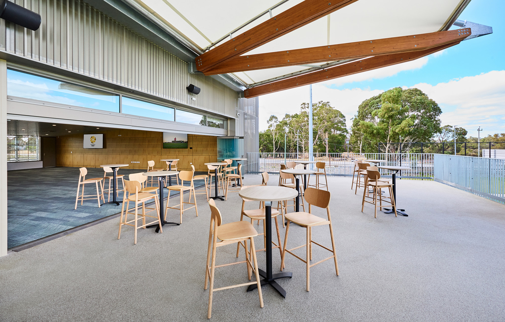 A photo of tables and chairs set up on a balcony area at the Sam Kerr Football Centre in Queens Park, Perth
