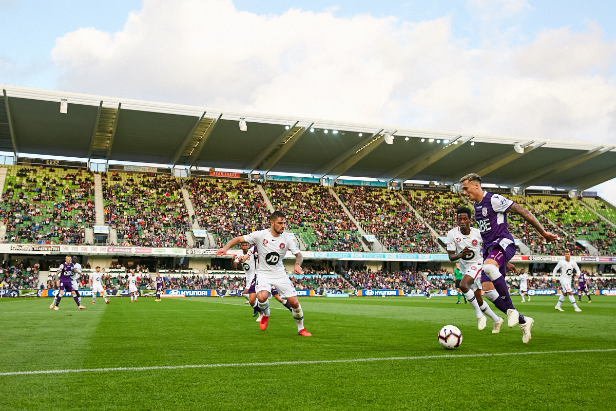 A photo of three football players competing for the ball at HBF Park