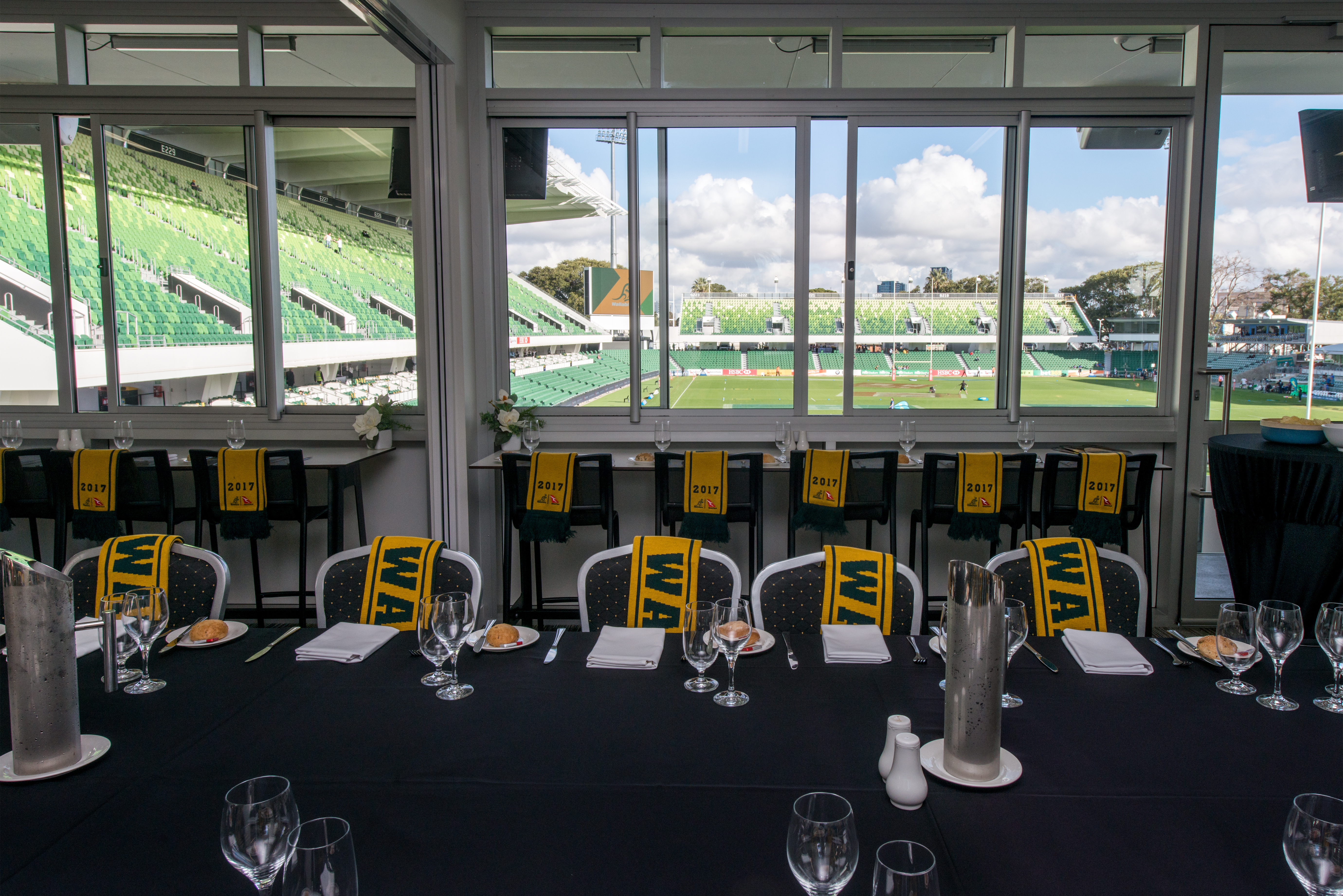 A photo of a function room located at HBF Park, with several seats being draped with Wallabies scarves