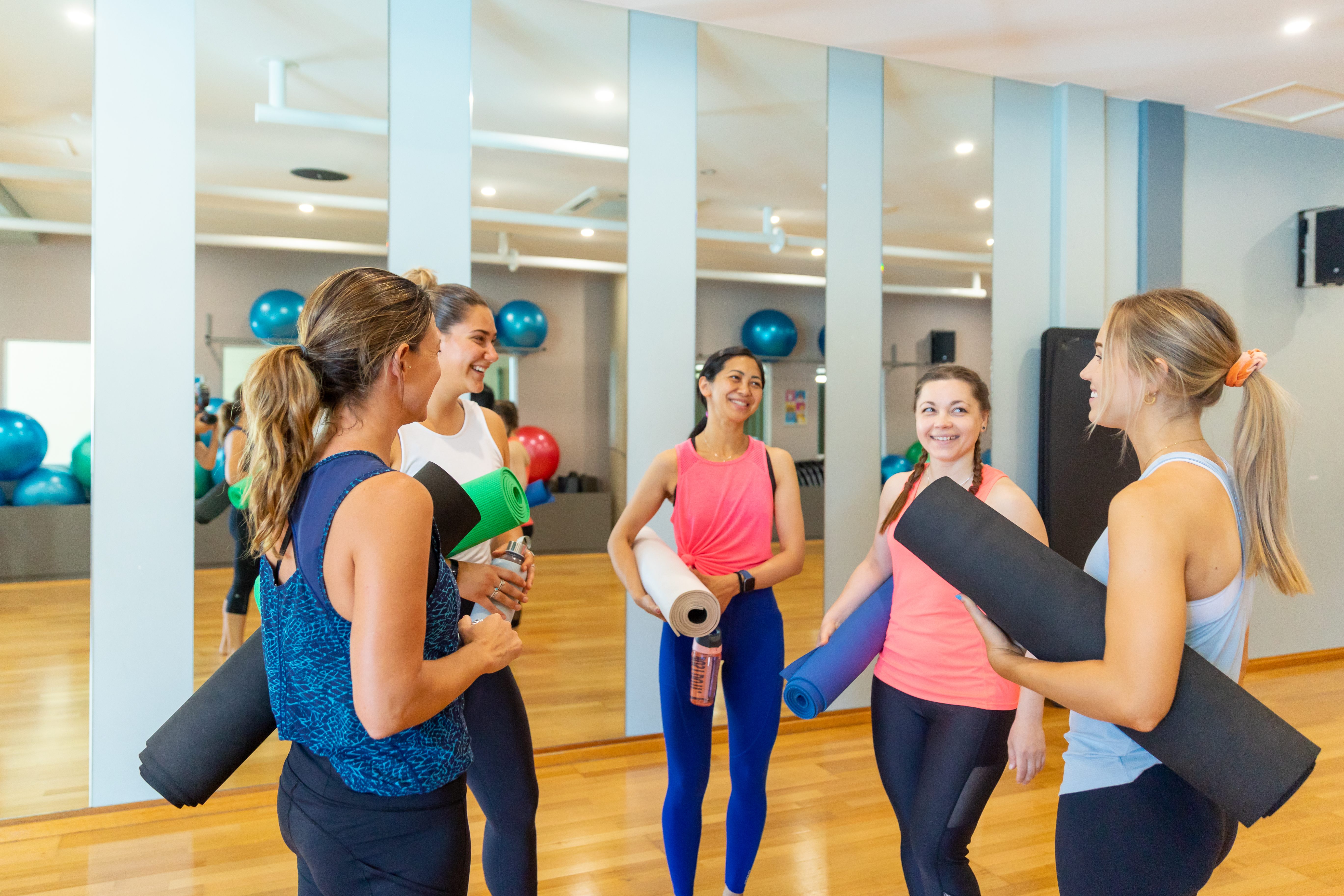 Women in active wear talking amongst themselves
