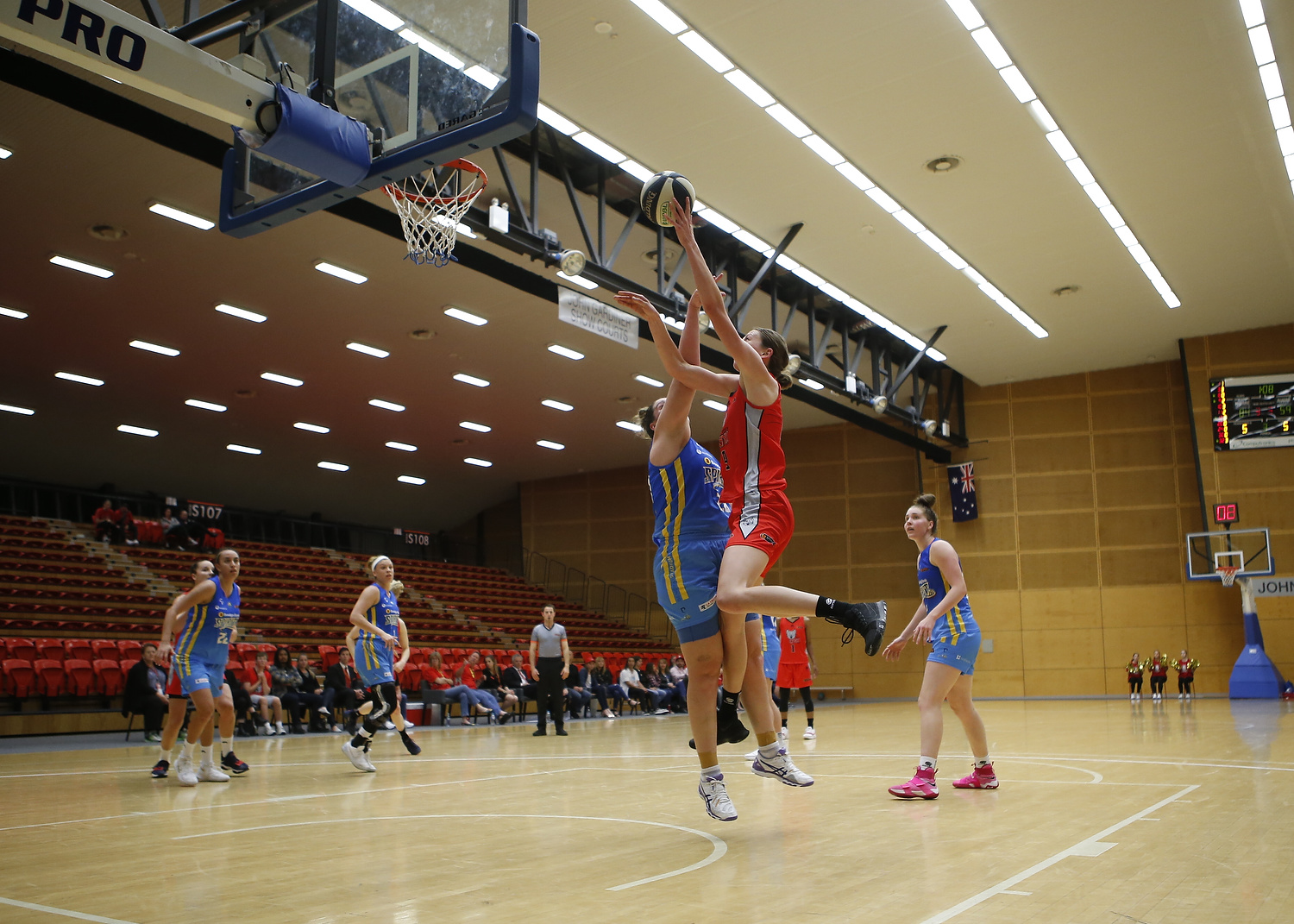 An action shot of a WNBL basketball game being played at the Bendat Basketball Centre