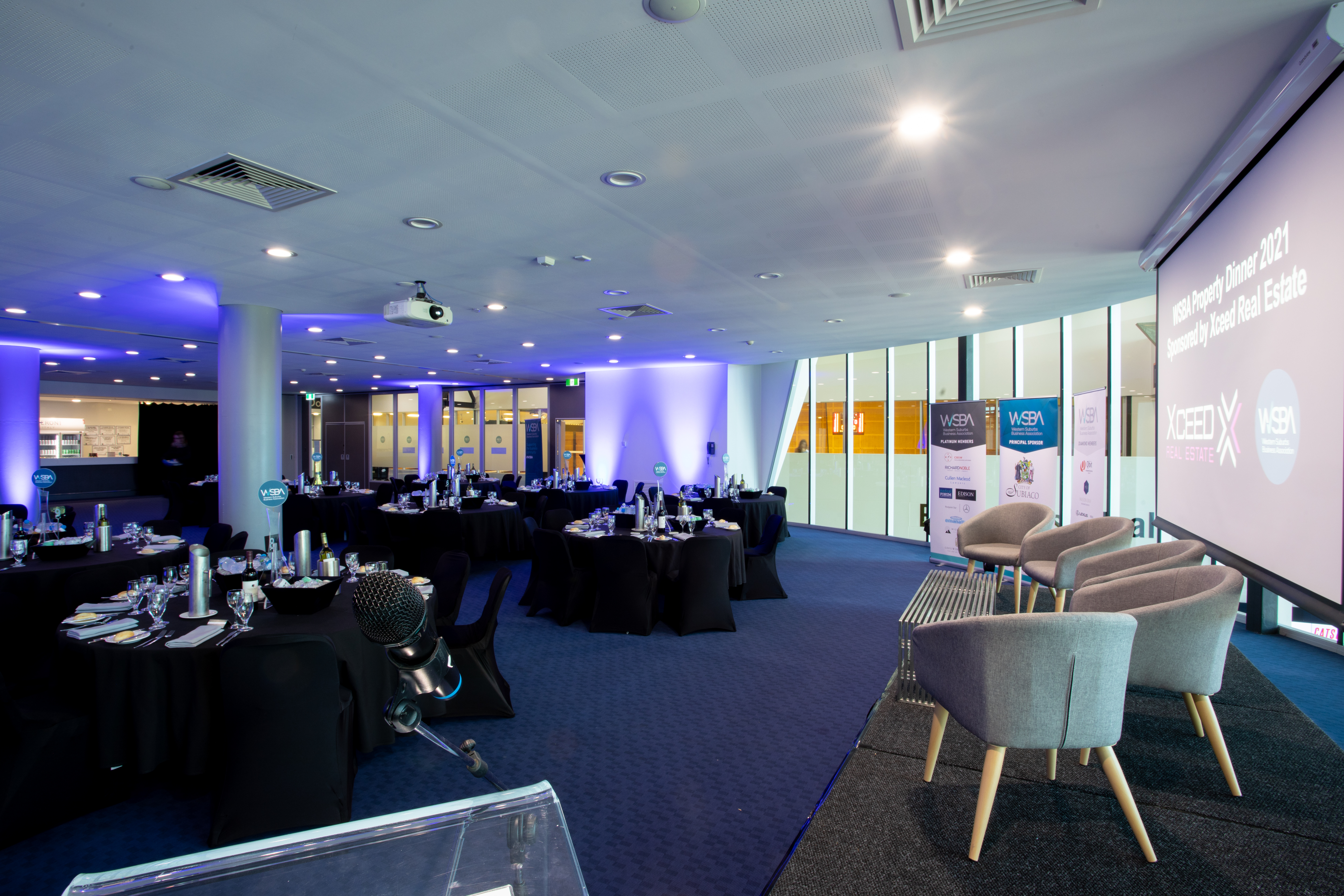 A photo of one of the function spaces at Bendat Basketball Centre, complete with tables, chairs, and table settings