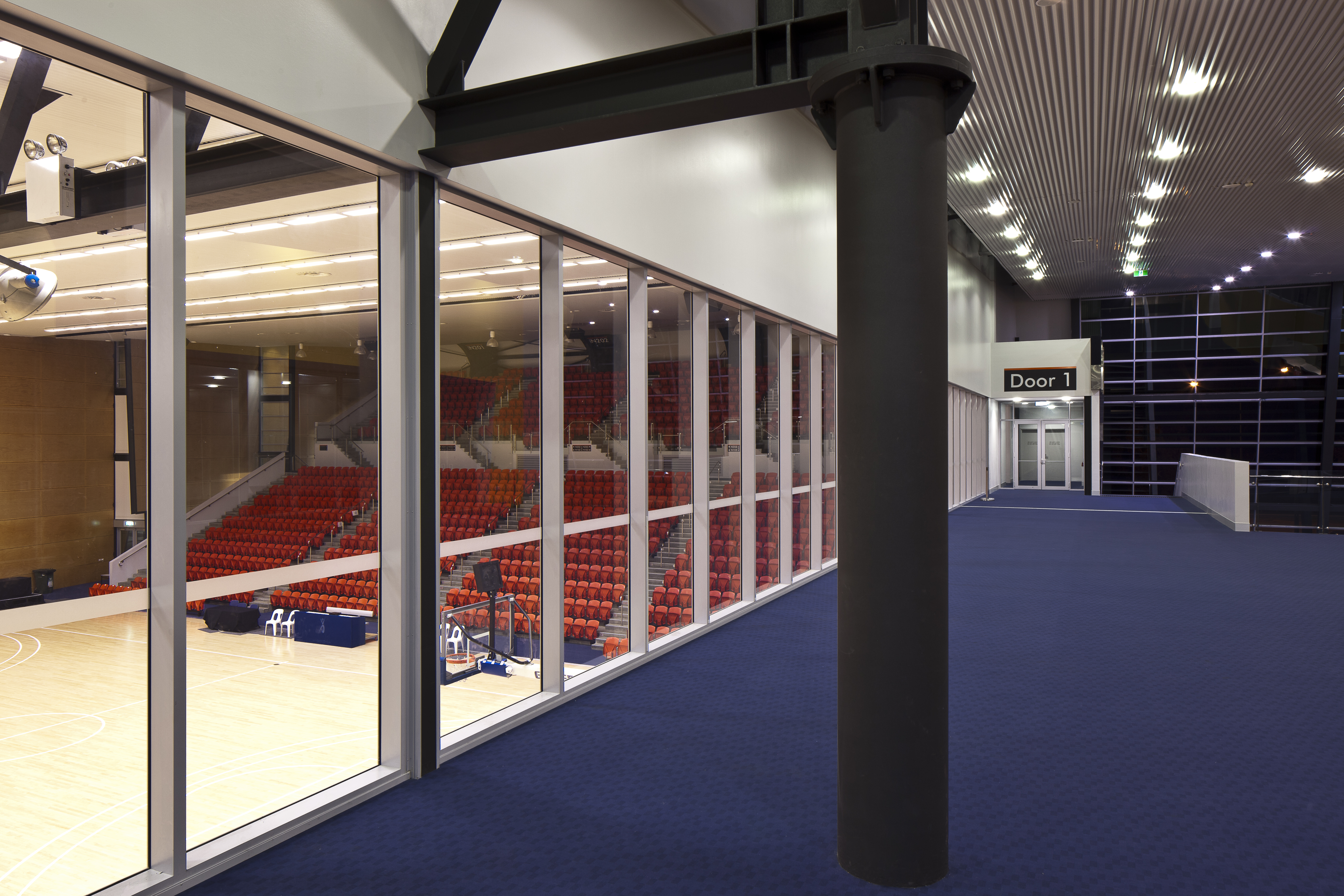 A photo of a carpeted area overlooking some basketball courts at Bendat Basketball Centre