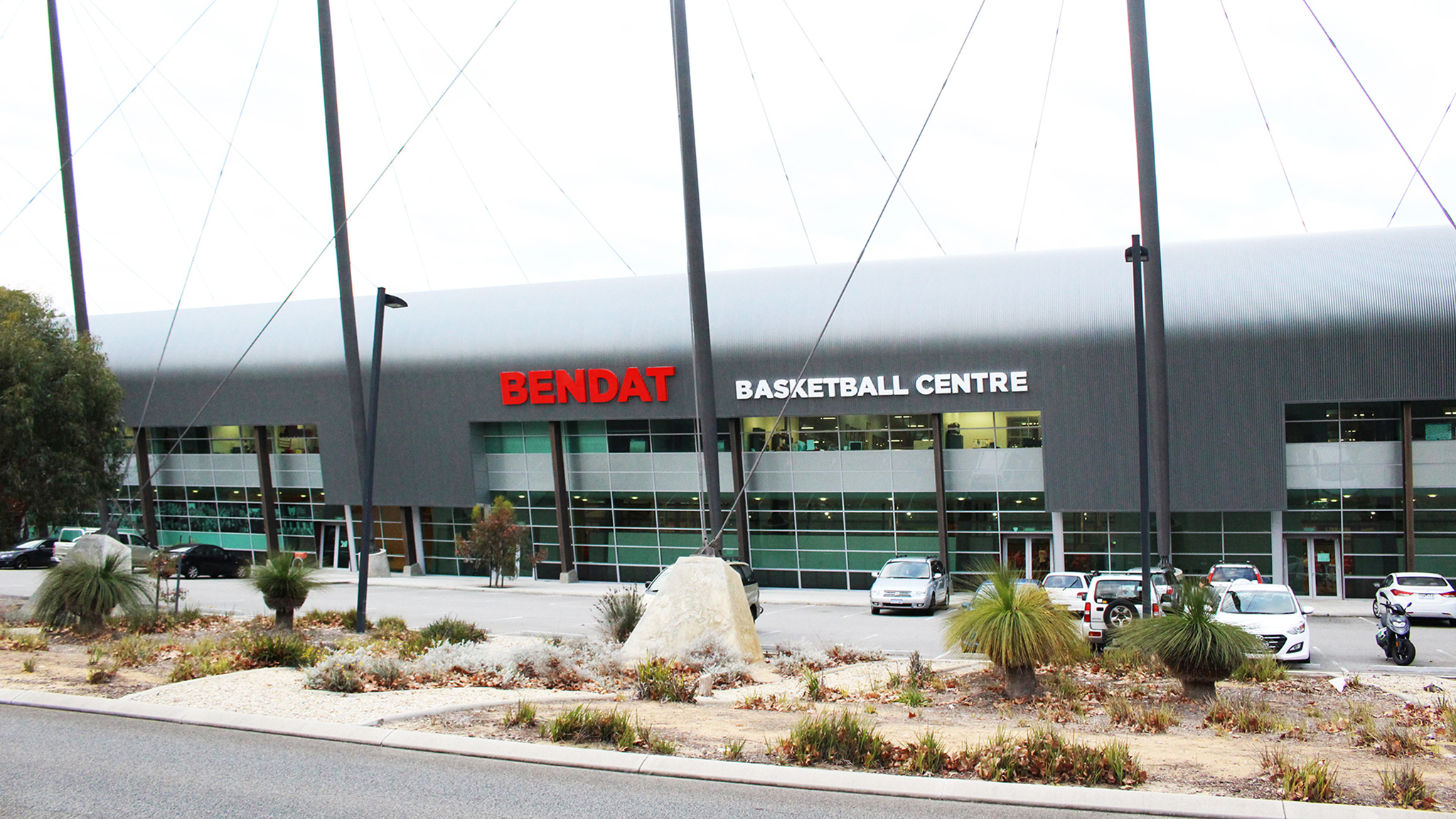 A photo of the exterior of the Bendat Basketball Centre building and carpark