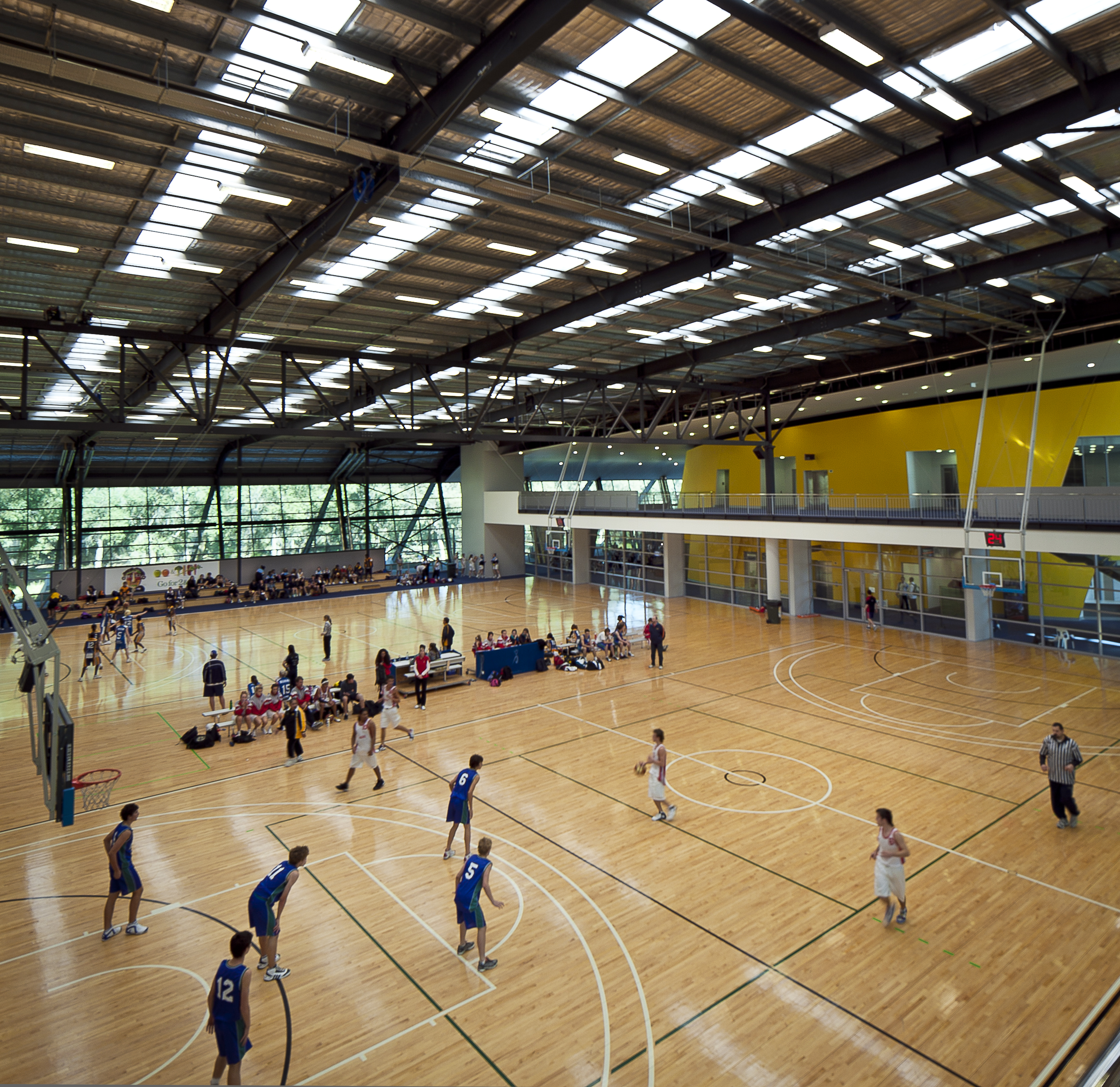 A photo of a game of basketball being played on one of the practice courts at Bendat Basketball Centre