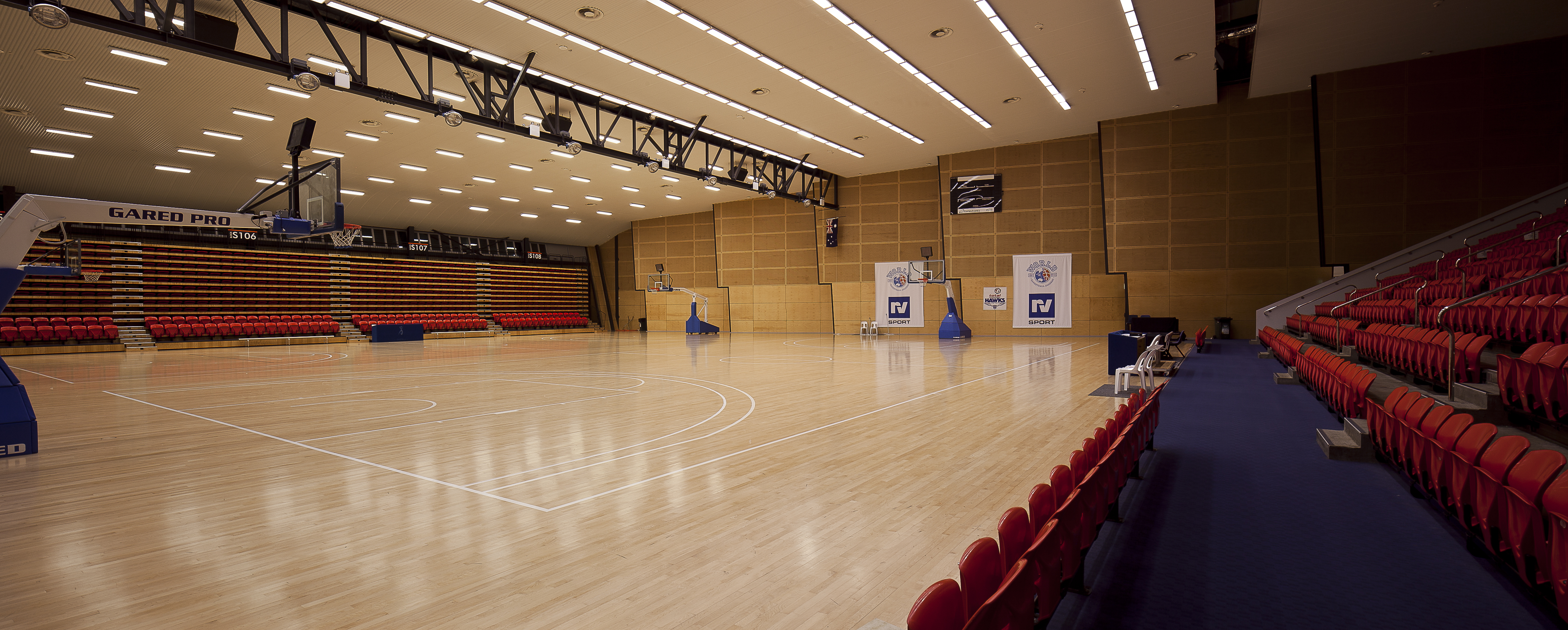 A photo of the main indoor court and seating bleachers at Bendat Basketball Centre