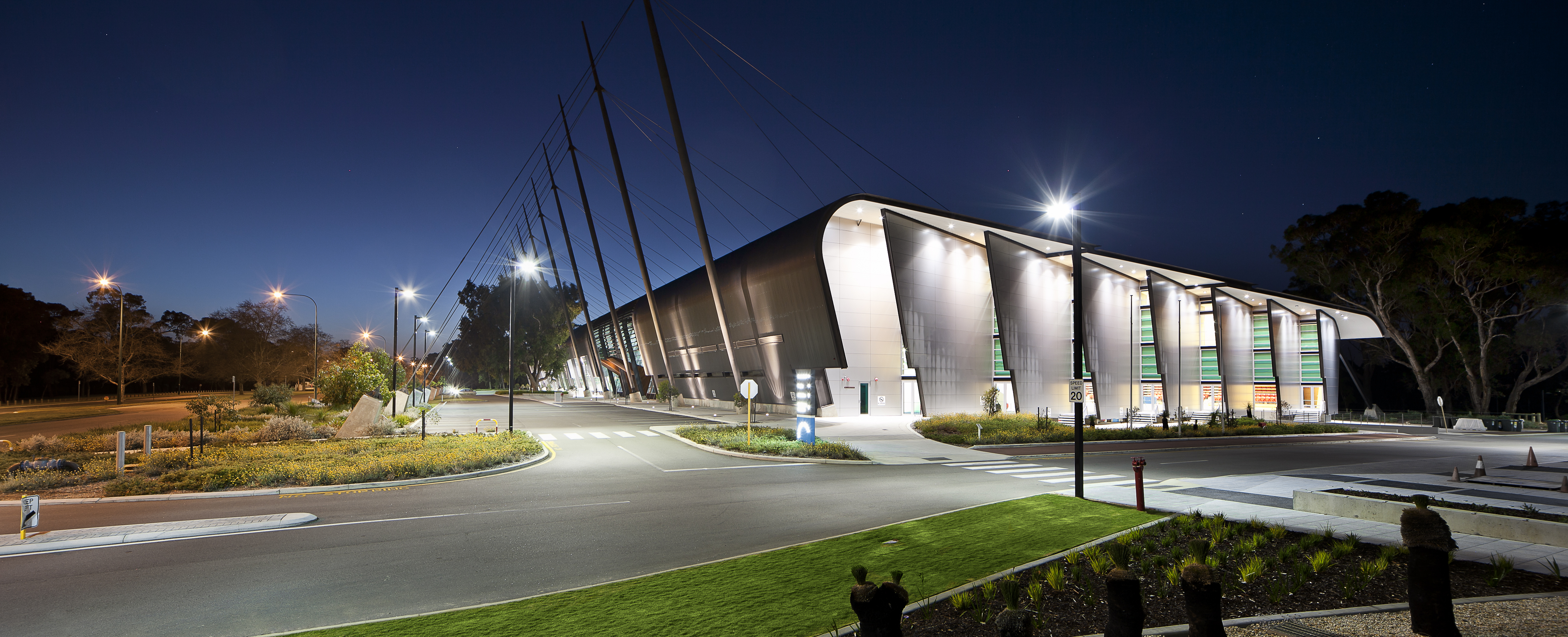 A photo taken at night time of an illuminated Bendat Basketball Centre