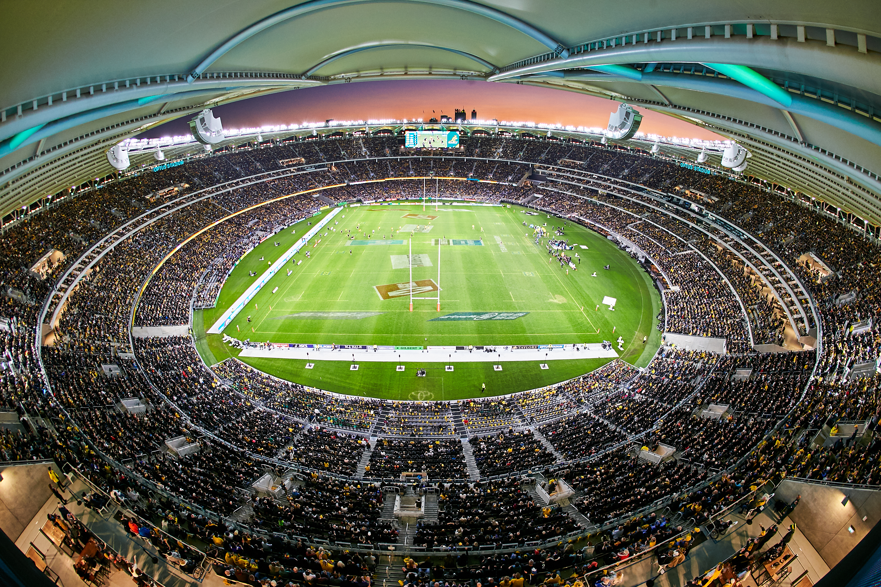 A photo taken from the top of the seating stands at Optus Stadium, showing the entire internal structure, including seating and field