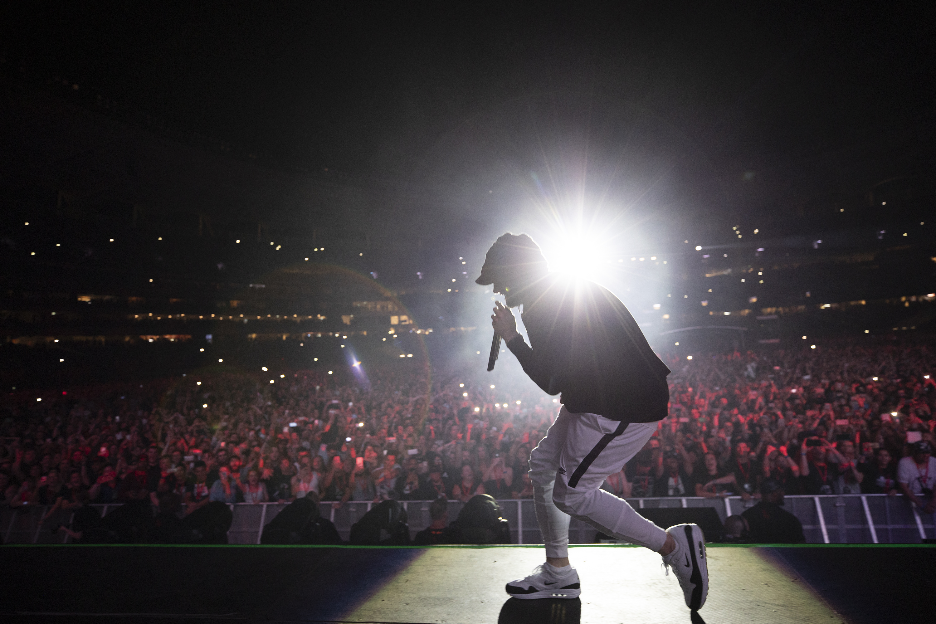 A photo of Eminem performing to a large crowd at Optus Stadium