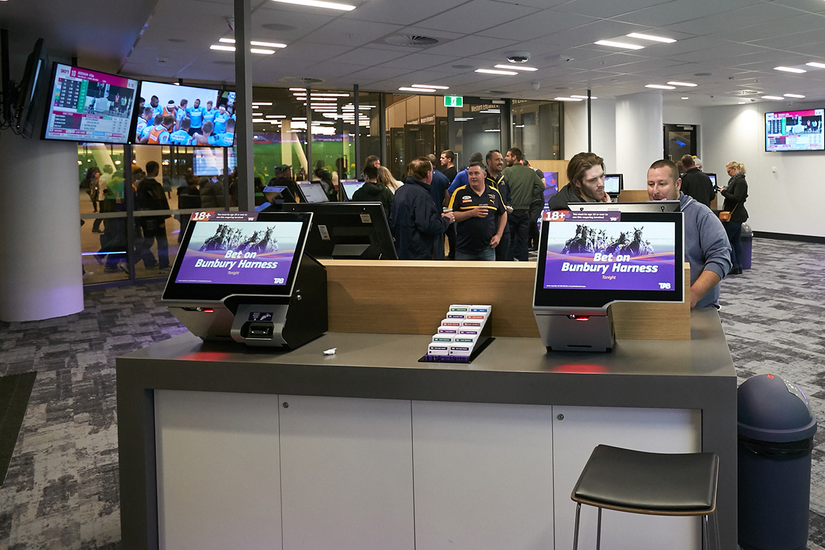 A photo of two interactive screens inside of a TAB section at Optus Stadium
