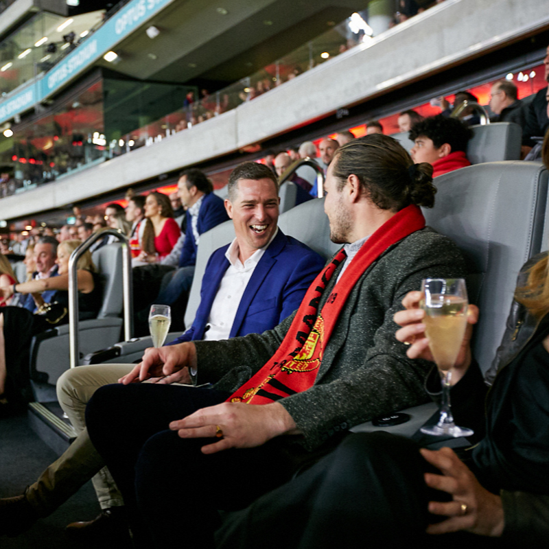 A close up shot of people sitting in premium seating at Optus Stadium