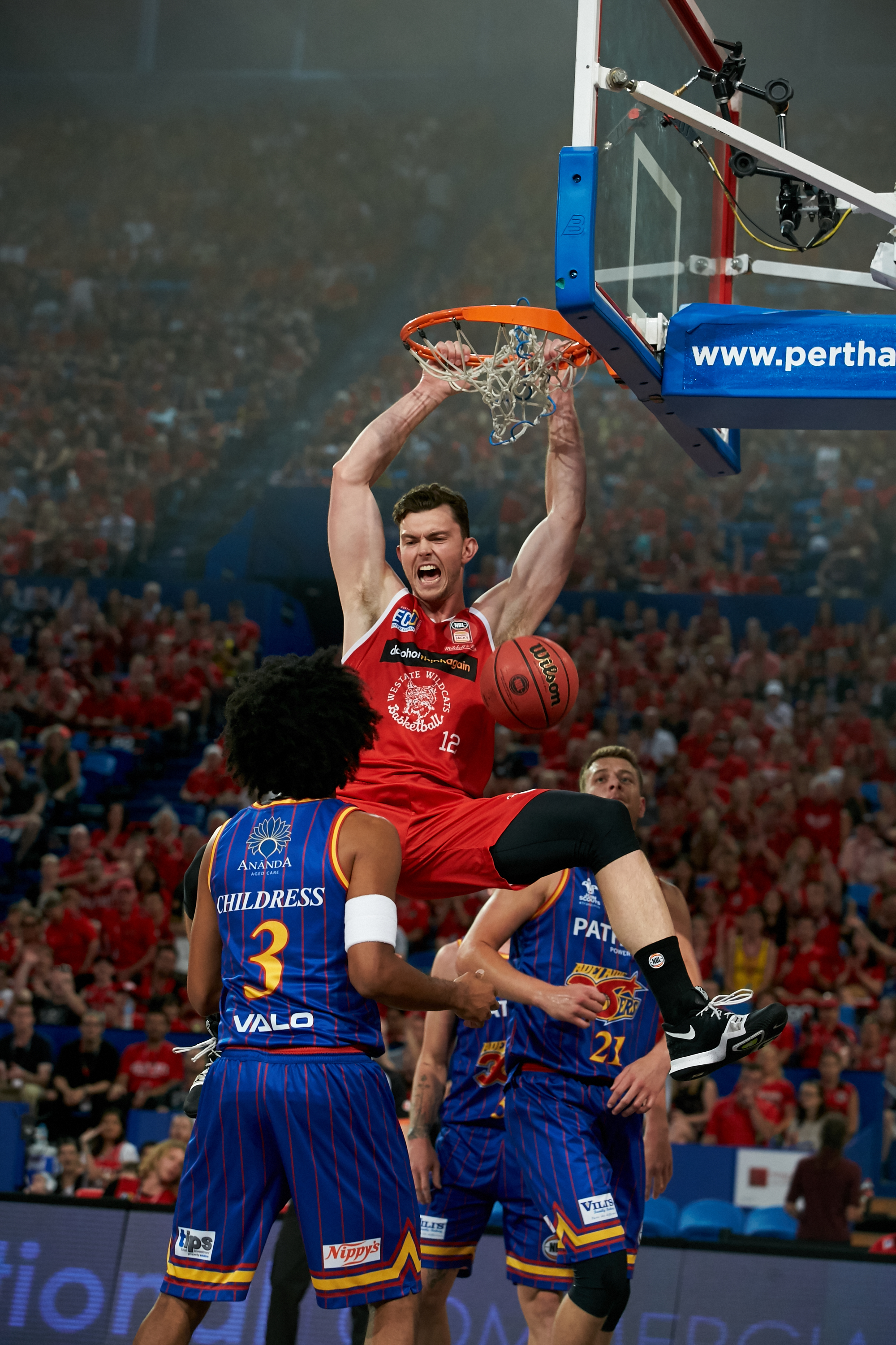 A close up photo of a Perth Wildcats player dunking during a game at RAC Arena in Perth