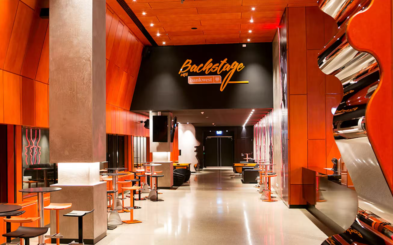A photo taken of an event space hallway with a sign above saying Backstage with Bankwest at RAC Arena in Perth