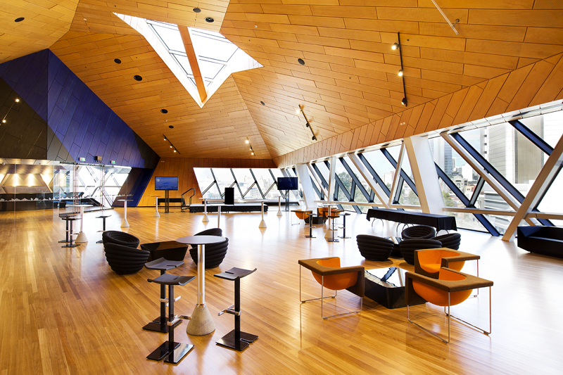 A photo taken of a large open room with very spaced out tables and chairs at RAC Arena in Perth