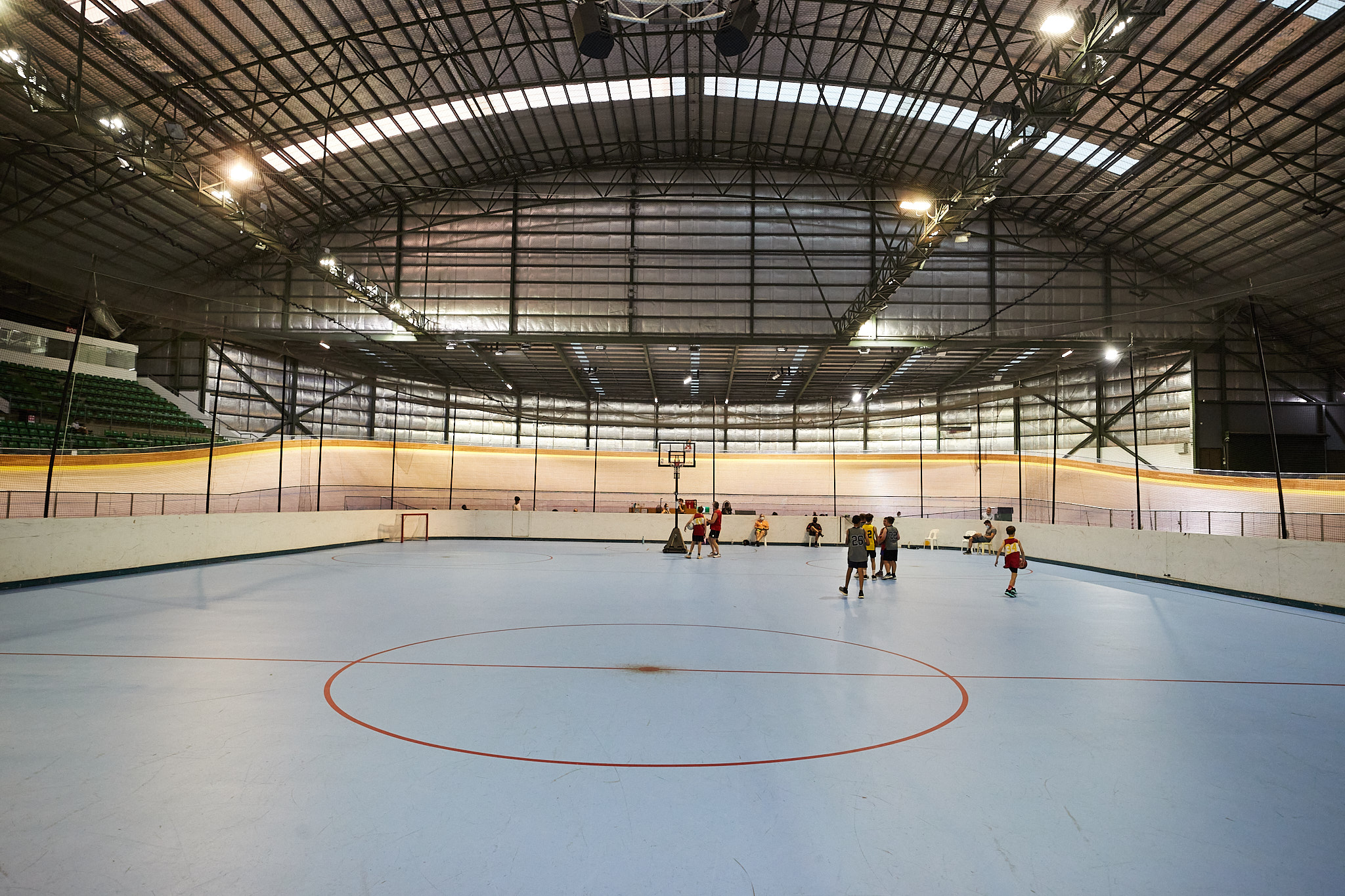A ground level photo of people basketball on the multipurpose court in the centre of the Speeddome in Middle Swan, Perth