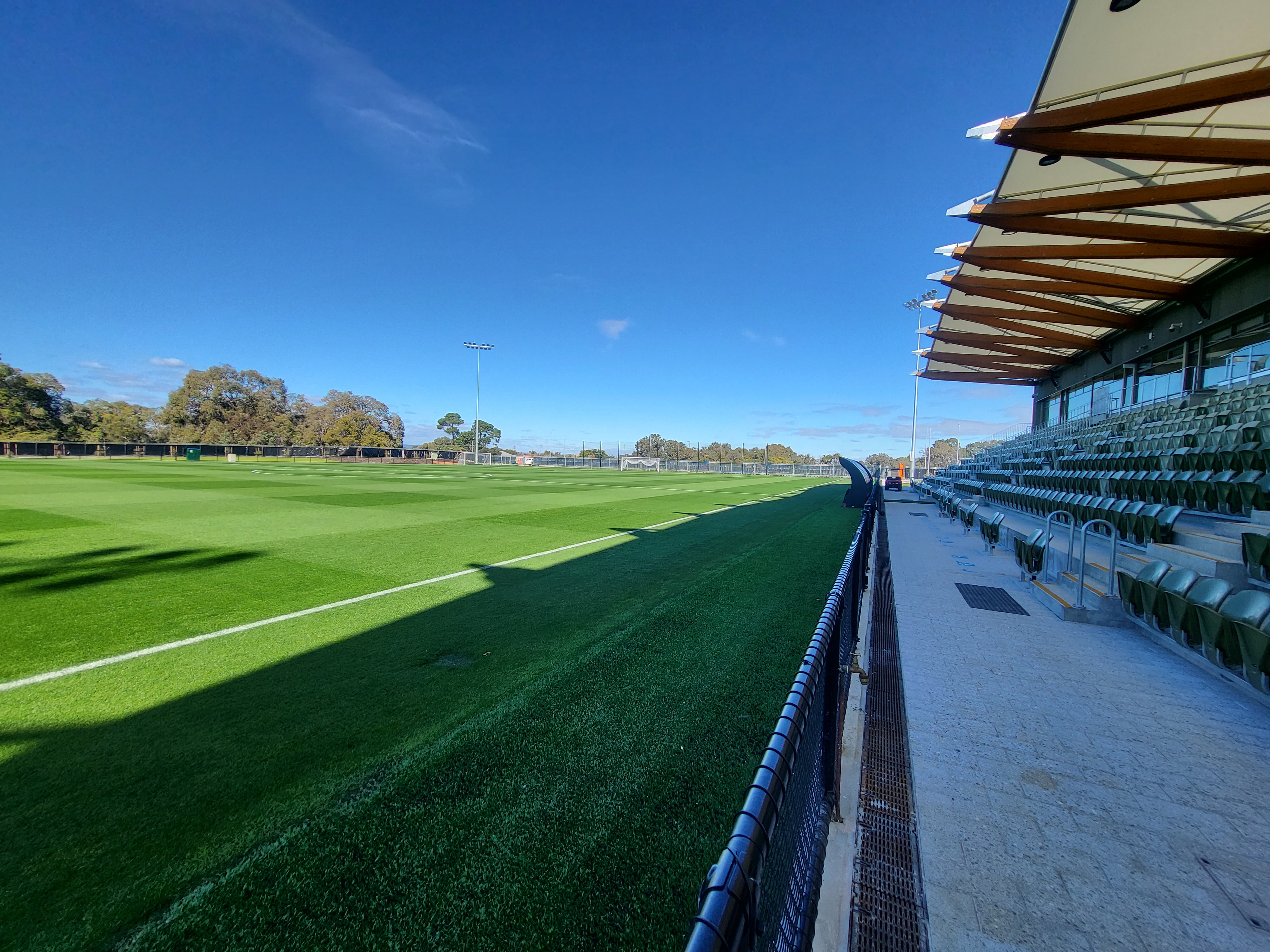 A photo showing the grandstand and side of one of the pitches at the Sam Kerr Football Centre in Queens Park