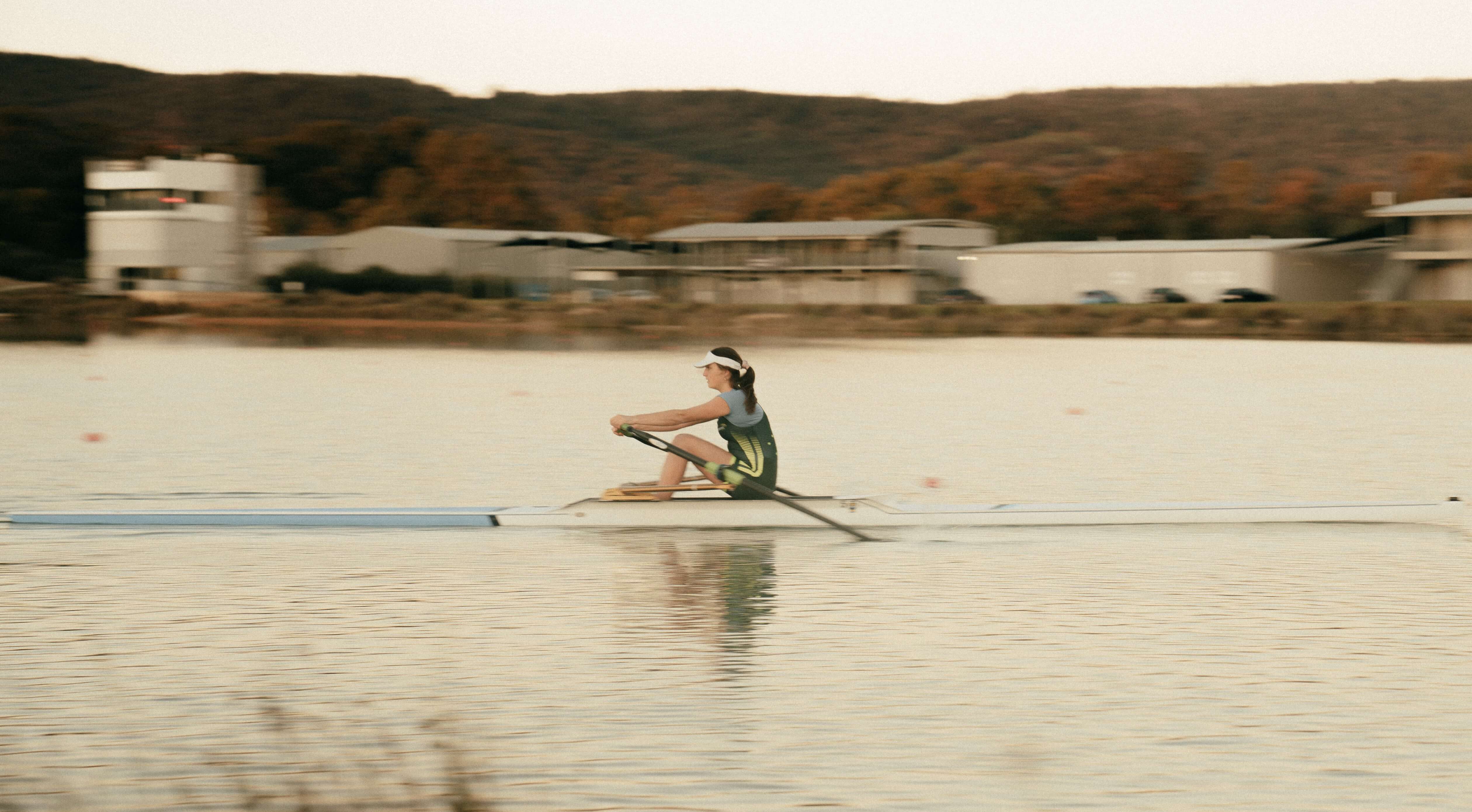 Side on photo of a solo rower on the water at Champion Lakes Regatta Centre