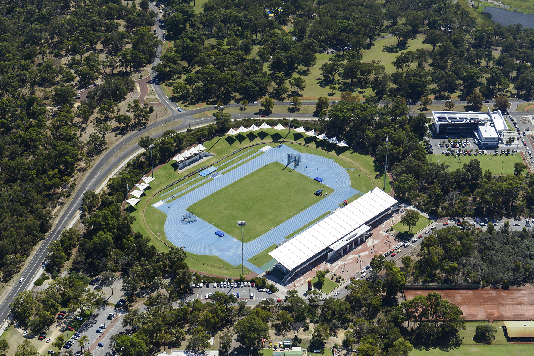 An aerial photo of the WA Athletics Stadium precinct, showing the main building as well as the circular running track