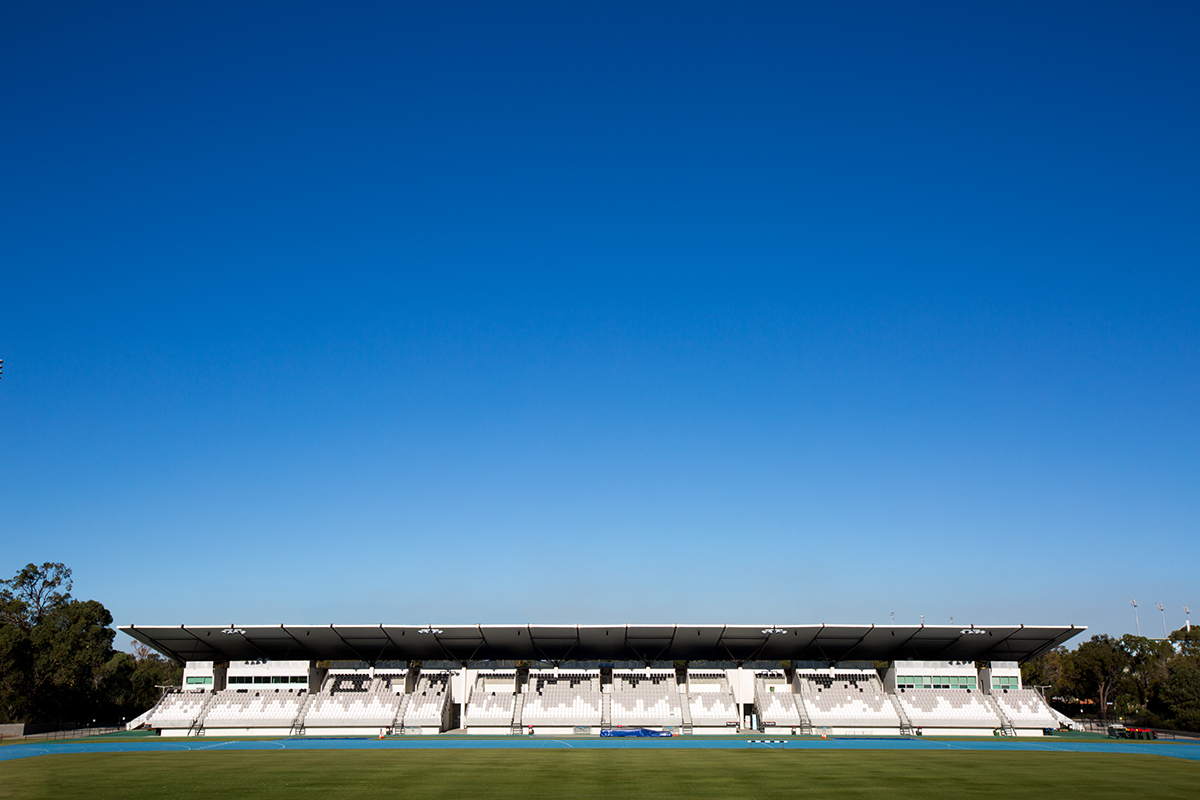 A side on photo of the straight sprint track and the main seating stand the WA Athletics Stadium